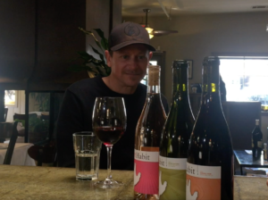 Jeff from Habit at bar with wine bottles